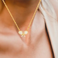 Gold Cross-Racquet Necklace