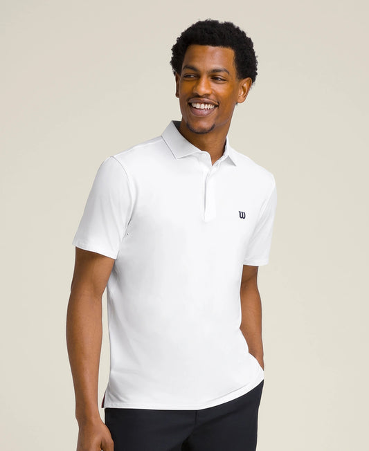 Man wearing a white polo shirt with a visible brand logo on a beige background